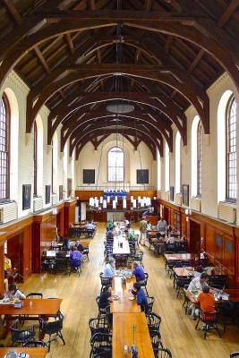 A dining hall filled with people eating.